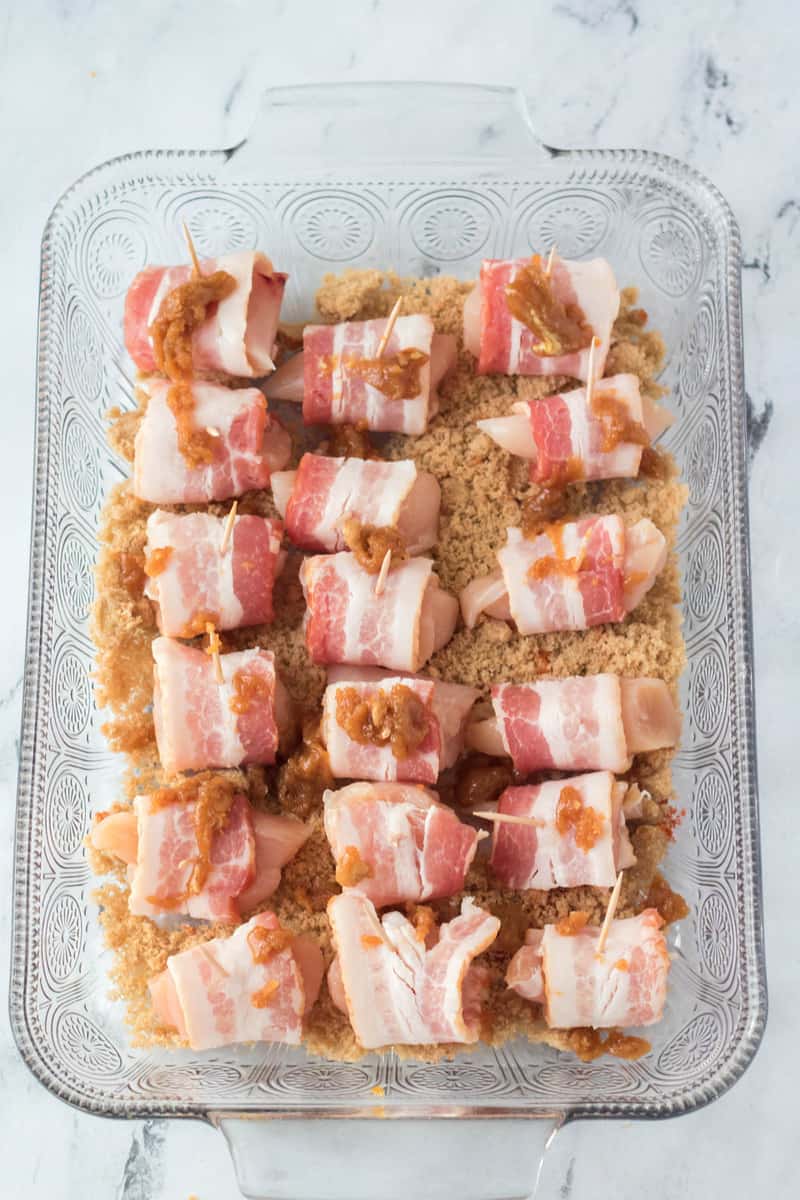 bacon wrapped chicken bites in baking dish