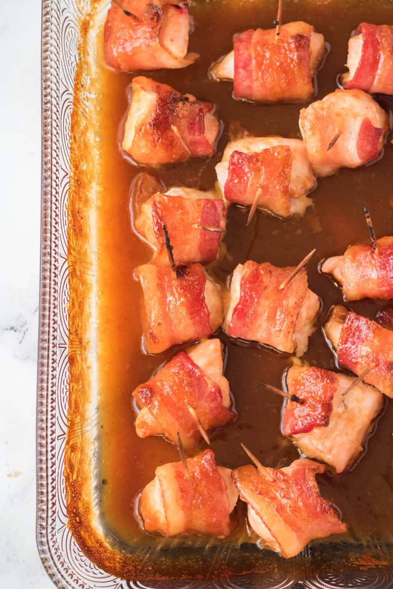 bacon wrapped chicken bites in bacon glaze in the baking dish