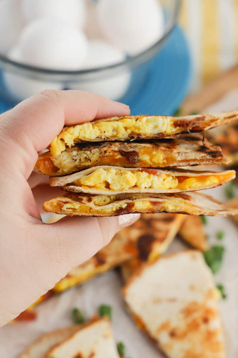 closeup of sliced quesadillas in hand