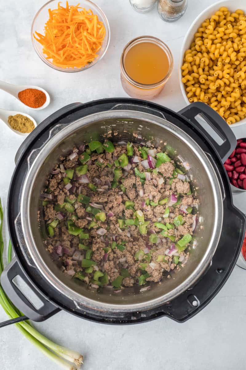 cooking the beef peppers and onions in the instant pot