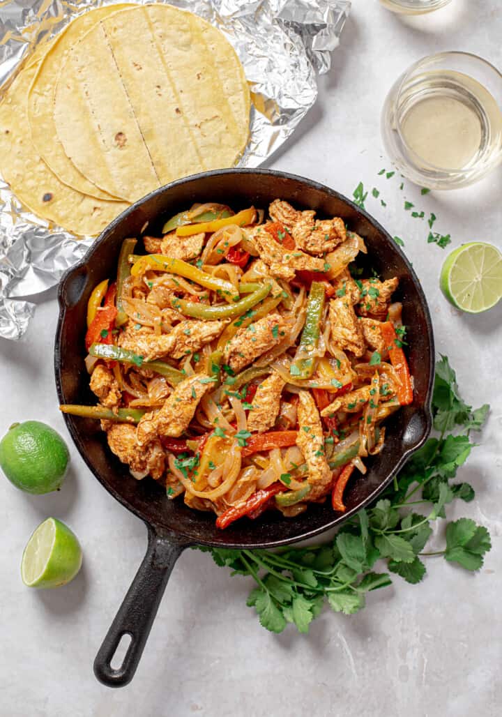peppers onions and chicken in a skillet
