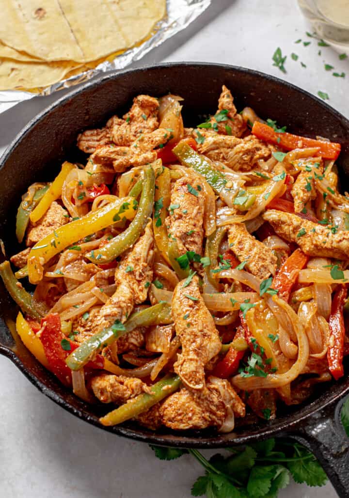 Chicken Fajitas cooked in a skillet.