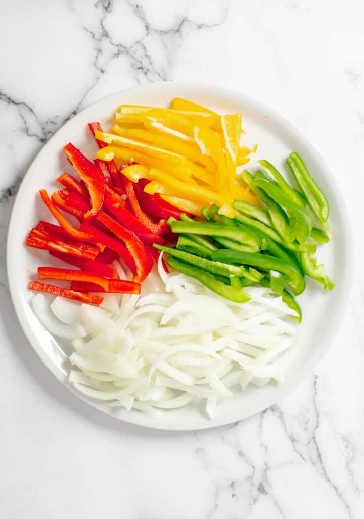 Plate of sliced peppers and onions for the fajitas.