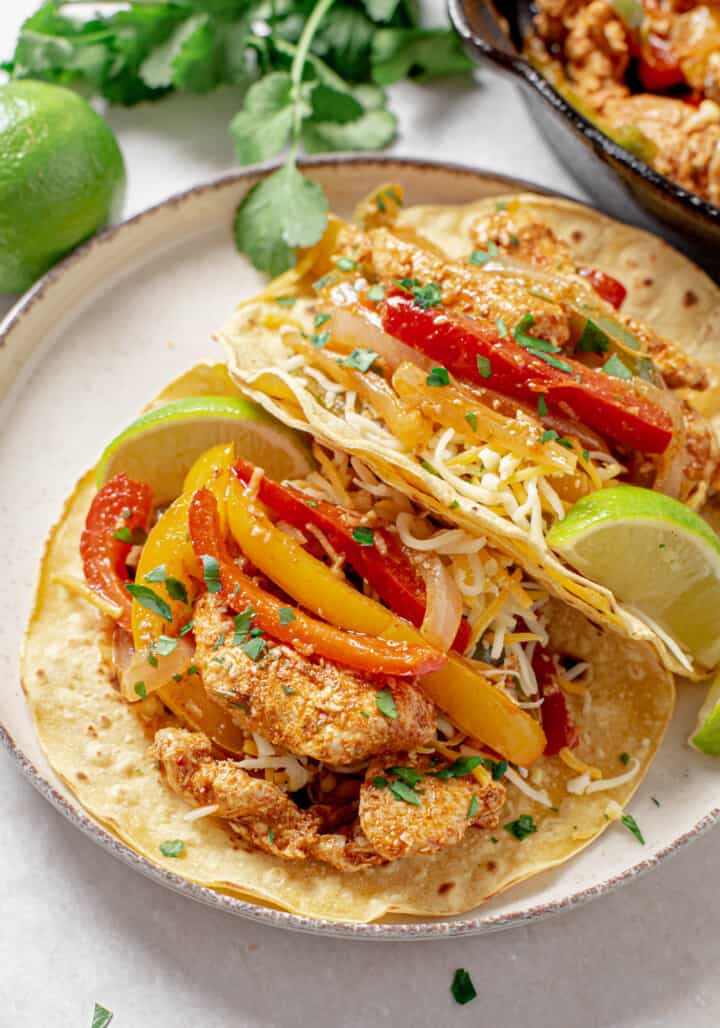 Closeup of chicken fajitas in tortillas.