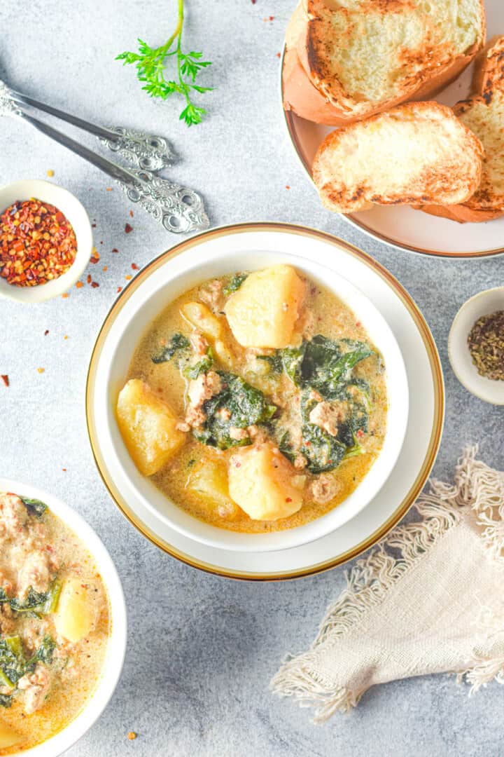 Instant Pot Zuppa Toscana in decorative bowl and bread on the side