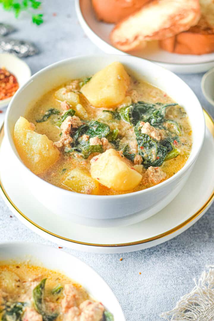 close up zuppa toscana in white bowl