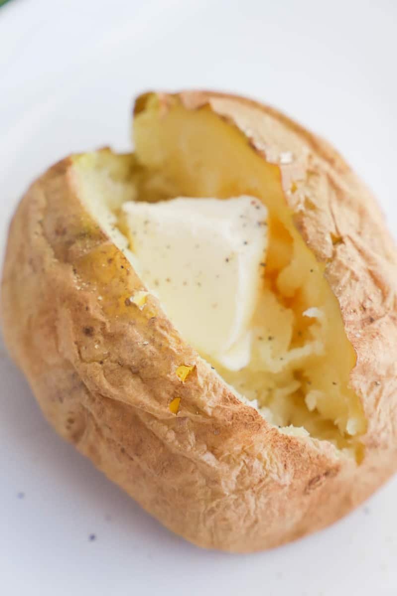 Microwave Baked Potato sliced open with butter in it