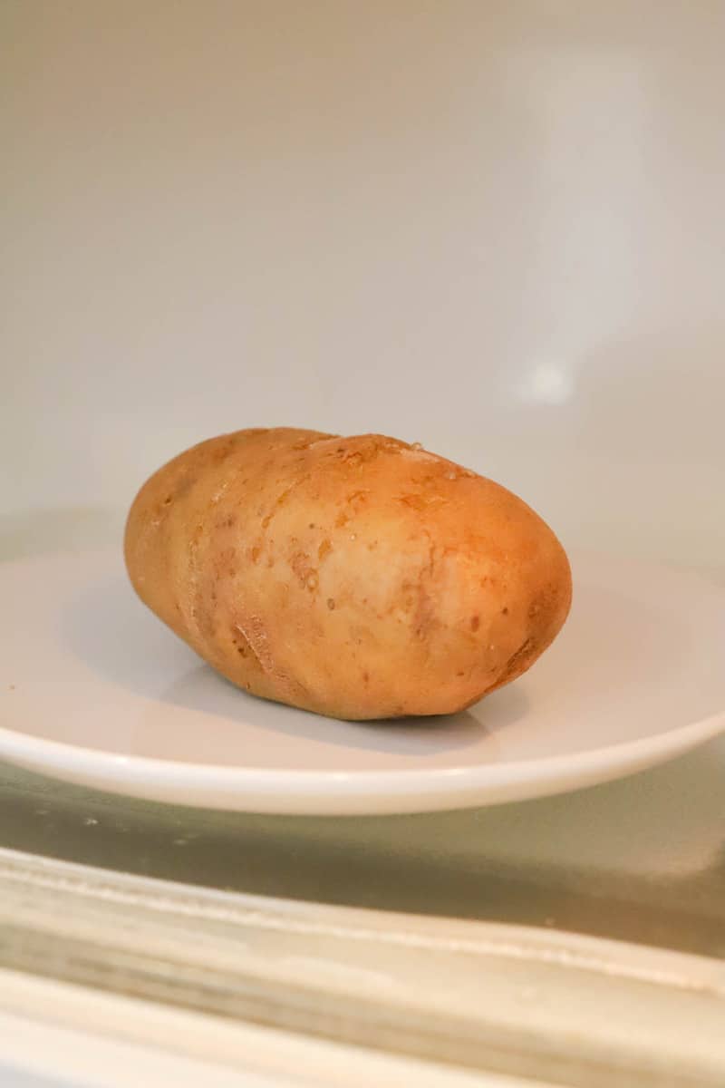 baked potato on white plate in microwave 