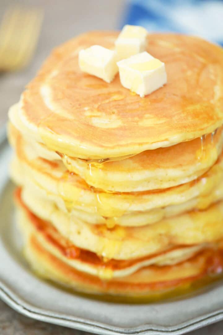 Pancakes stacked with butter and syrup