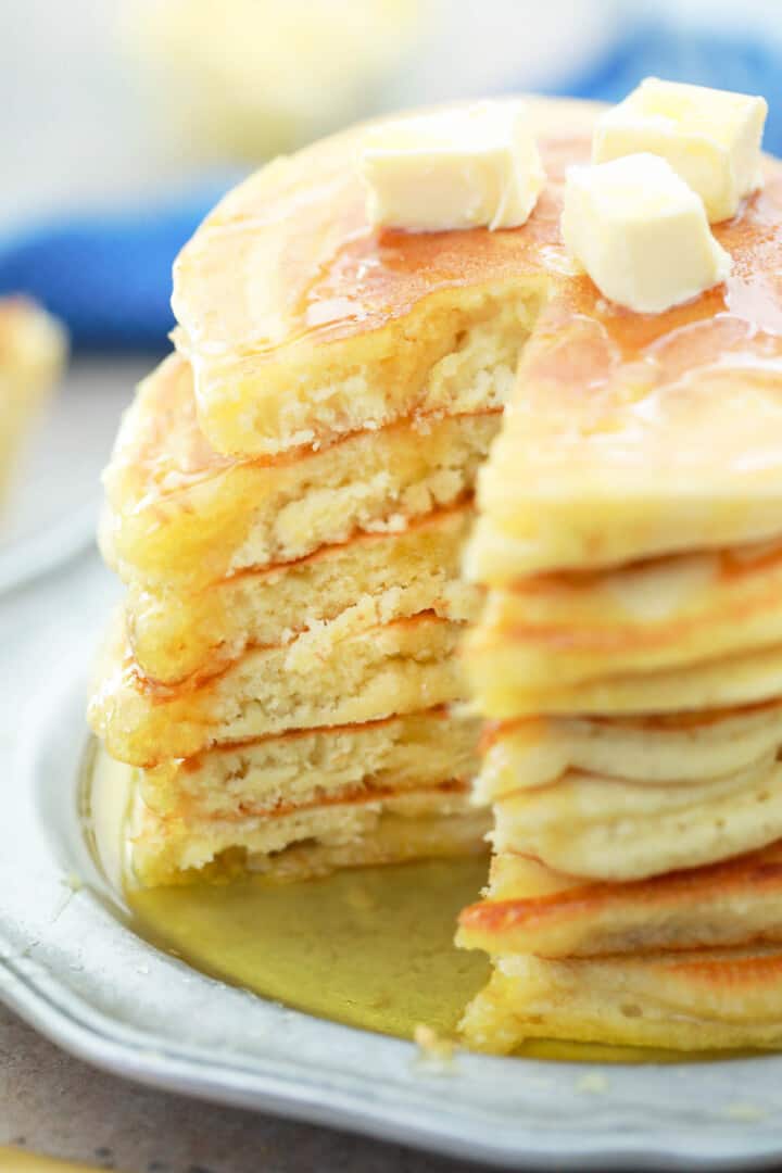closeup of stack of pancakes with syrup and butter
