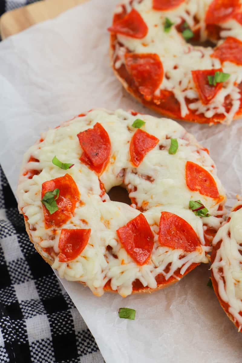 closeup of pizza bagels on serving board