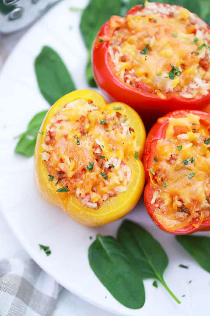 finished slow cooker stuffed peppers on white plate with garnish