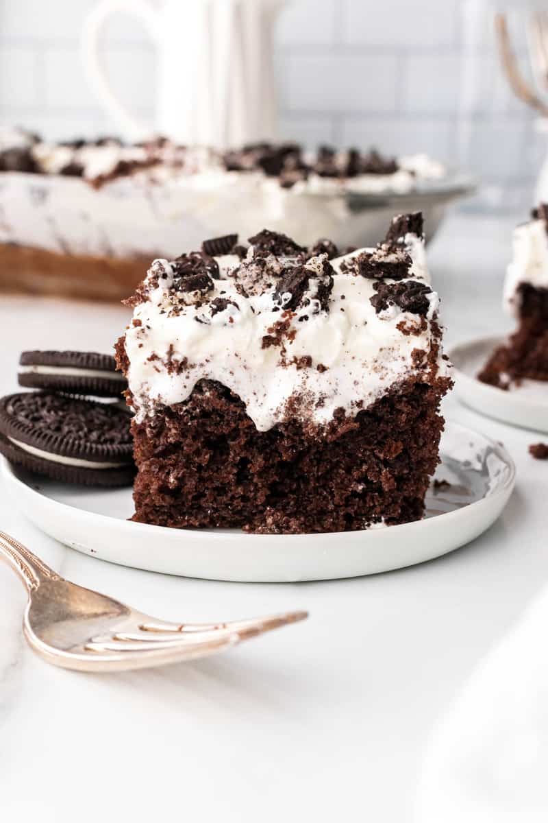 slice of Oreo poke cake on white plate