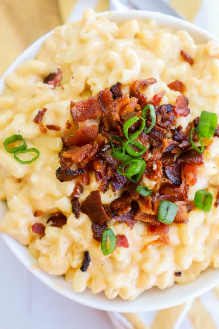 Bacon Mac and Cheese in white bowl topped with green onions