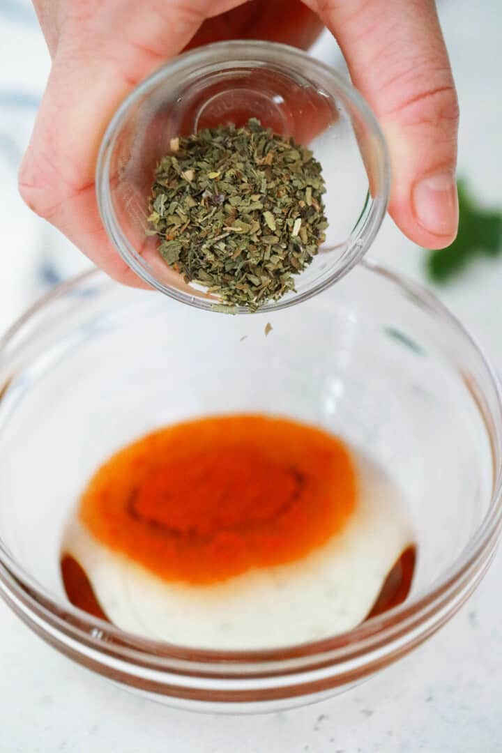 mixing together the seasoning and oil for the chicken breasts.