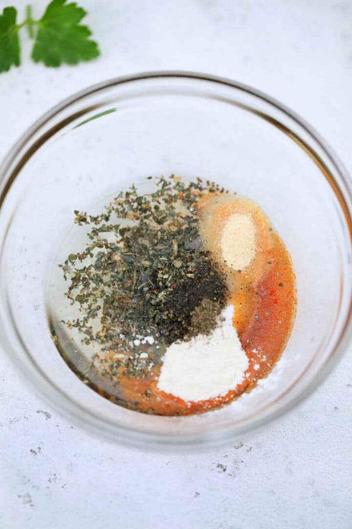 the seasoning and oils in a clear bowl for mixing.