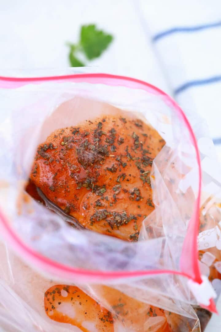 seasoned chicken breasts in freezer bag.