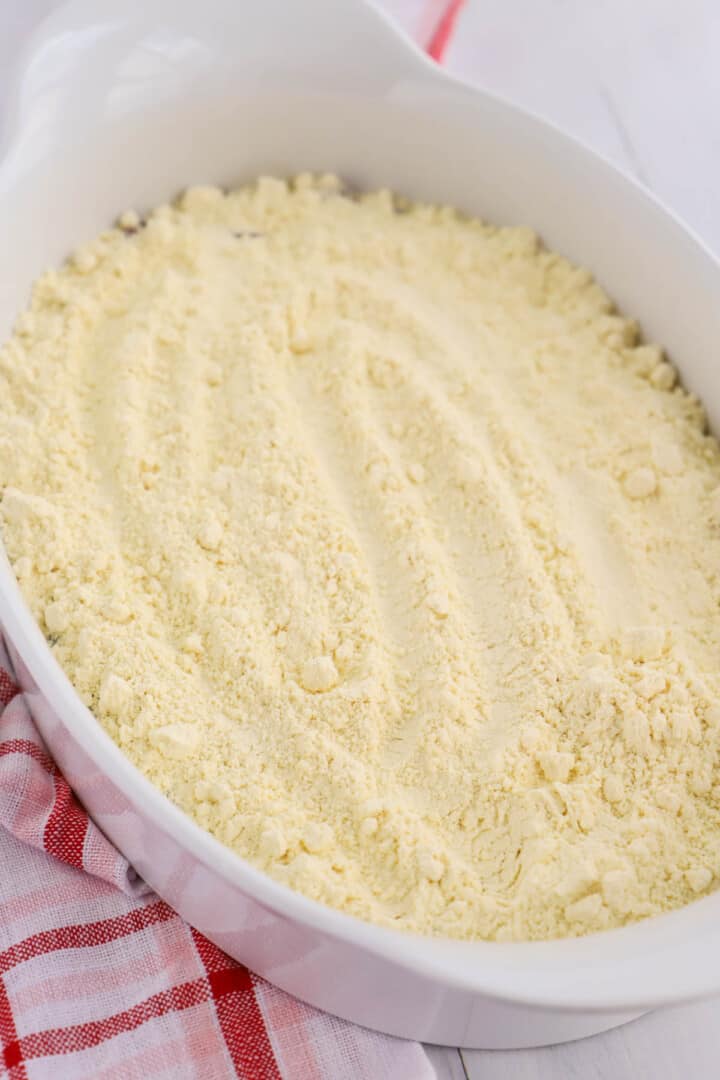 spreading the cake mix on top of the pie filling