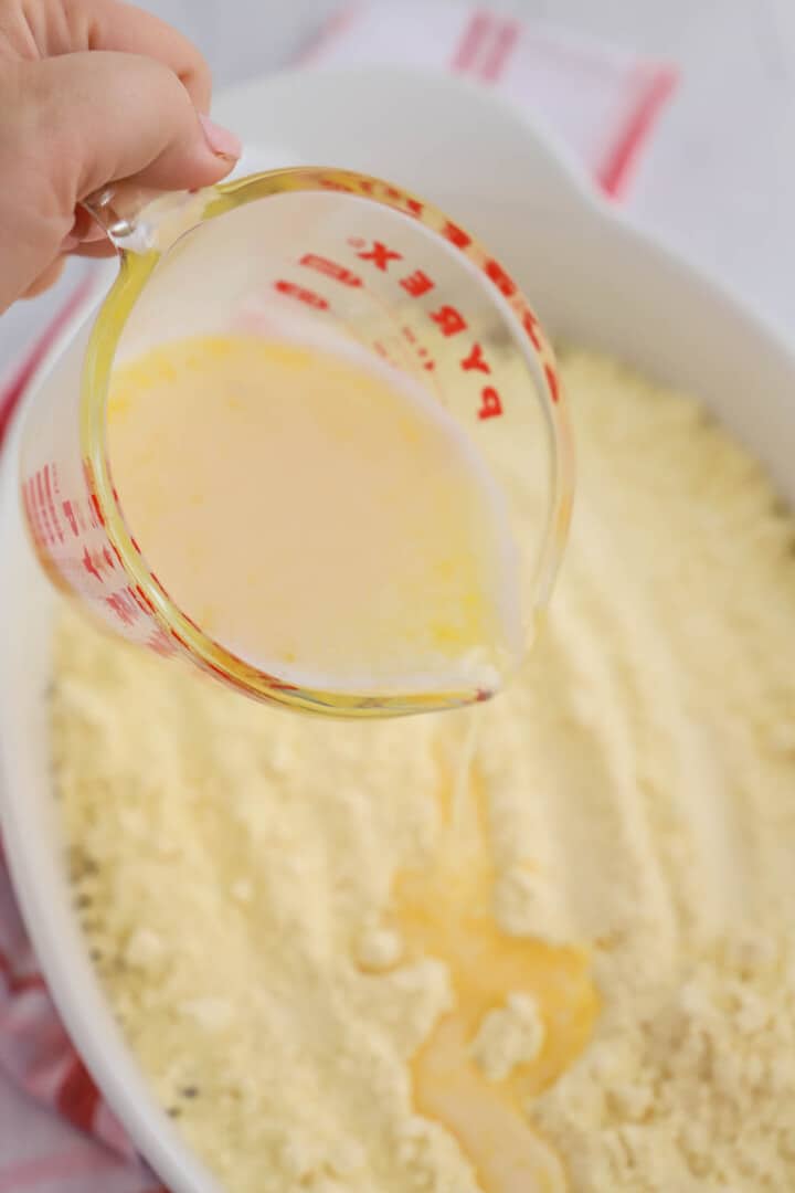 pouring the melted butter over the cake