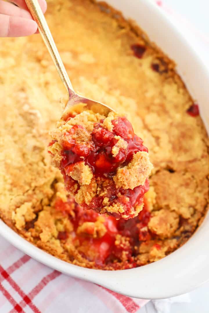 cherry dump cake on metal spoon close up