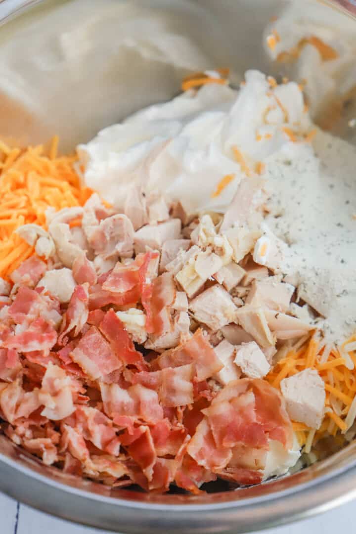 all ingredients for crack chicken dip in metal bowl