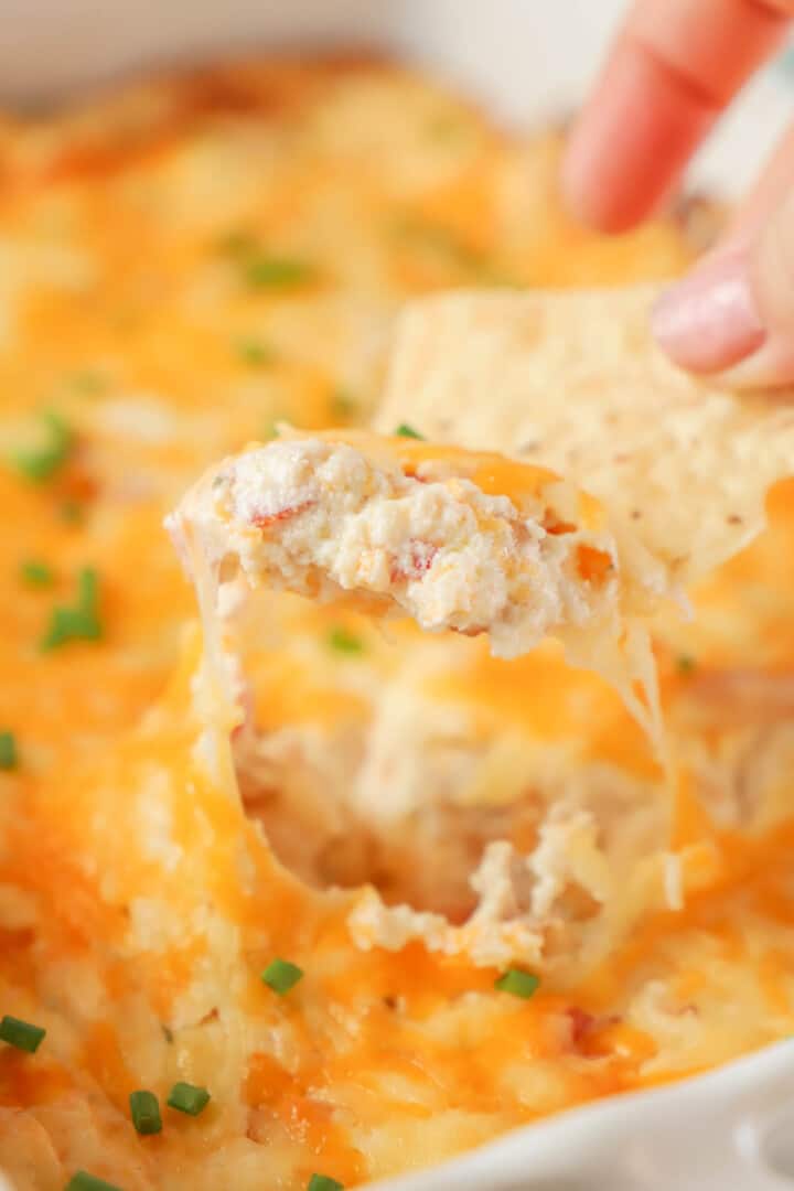 close up of crack chicken dip on a tortilla chip