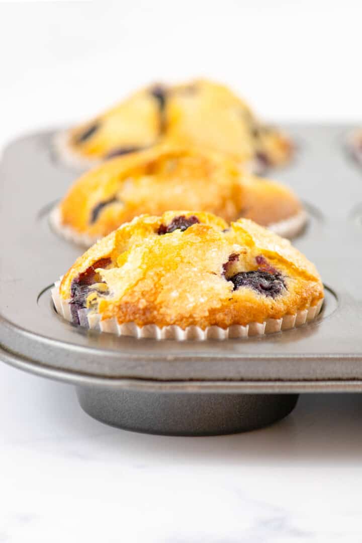 closeup of blueberry muffin in the muffin tin.