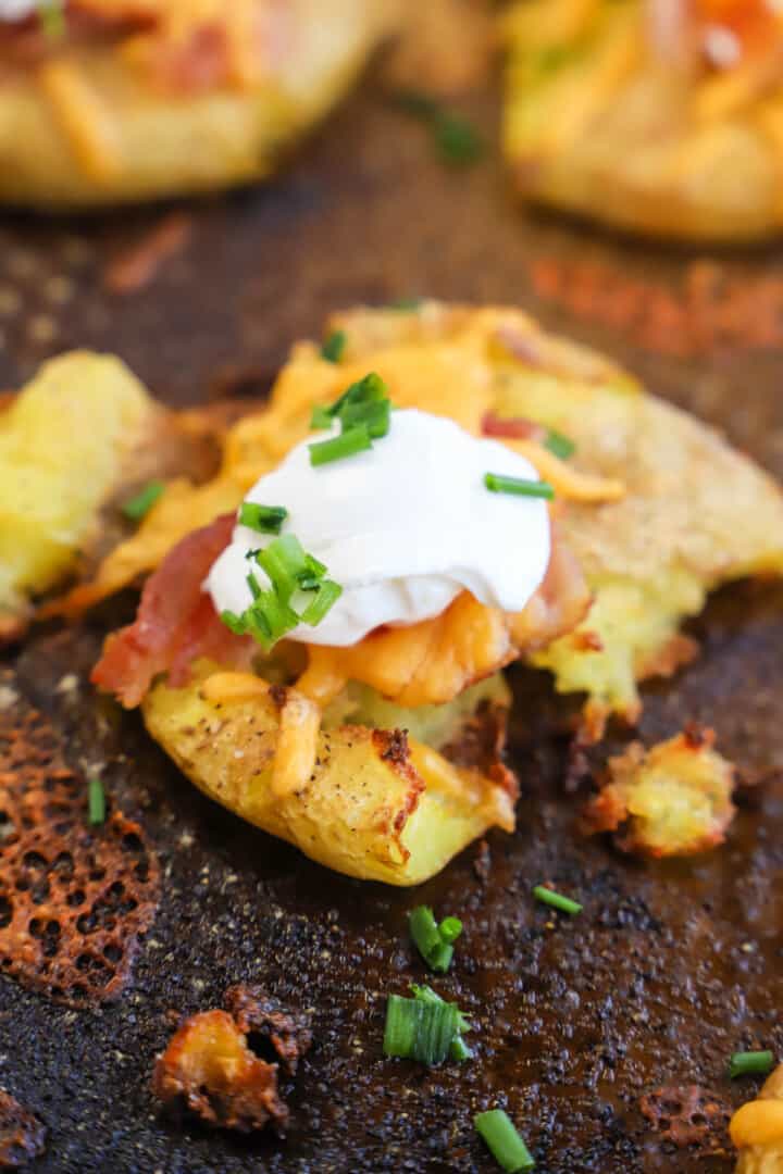 Loaded Smashed Potatoes on baking sheet closeup