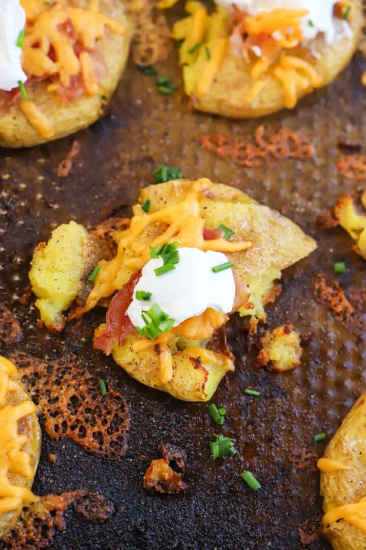 topping the baked potatoes with sour cream and onions