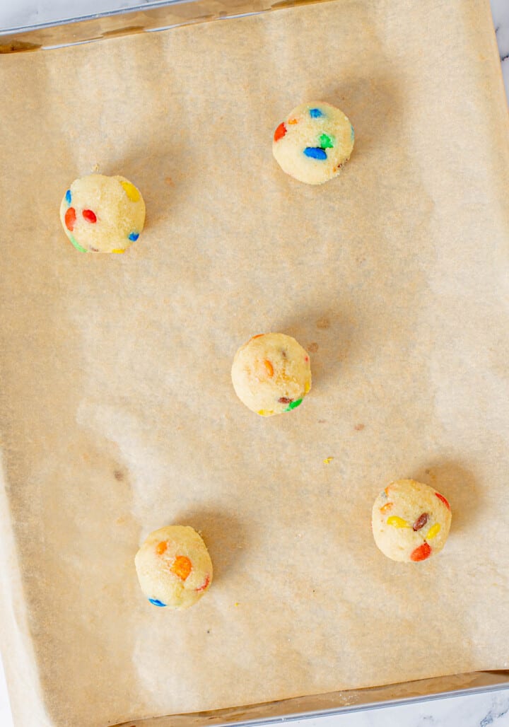 rolled cookie dough balls on baking sheet