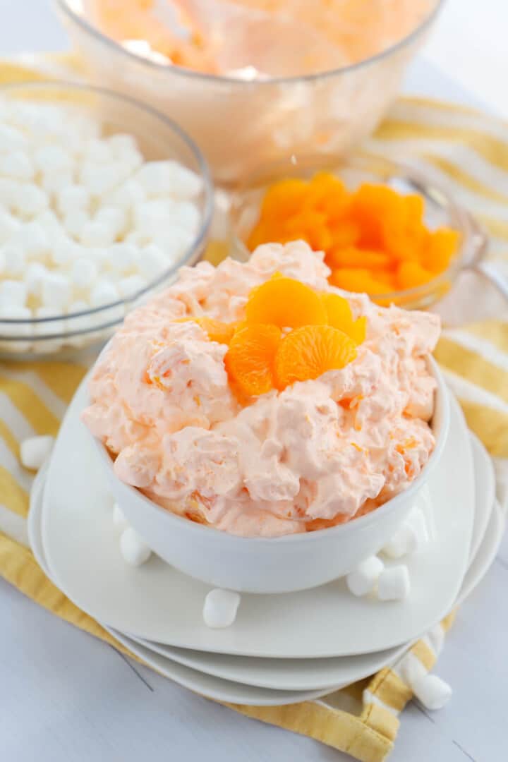 Orange Fluff in a white bowl topped with mandarin oranges