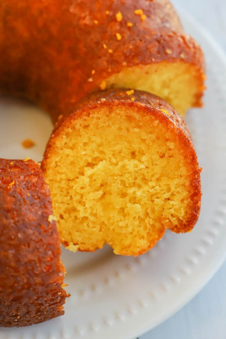 close up slice of orange juice cake on white serving tray