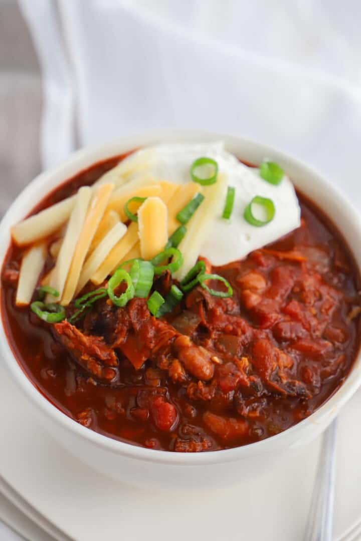 top view of pulled pork chili in white bowl