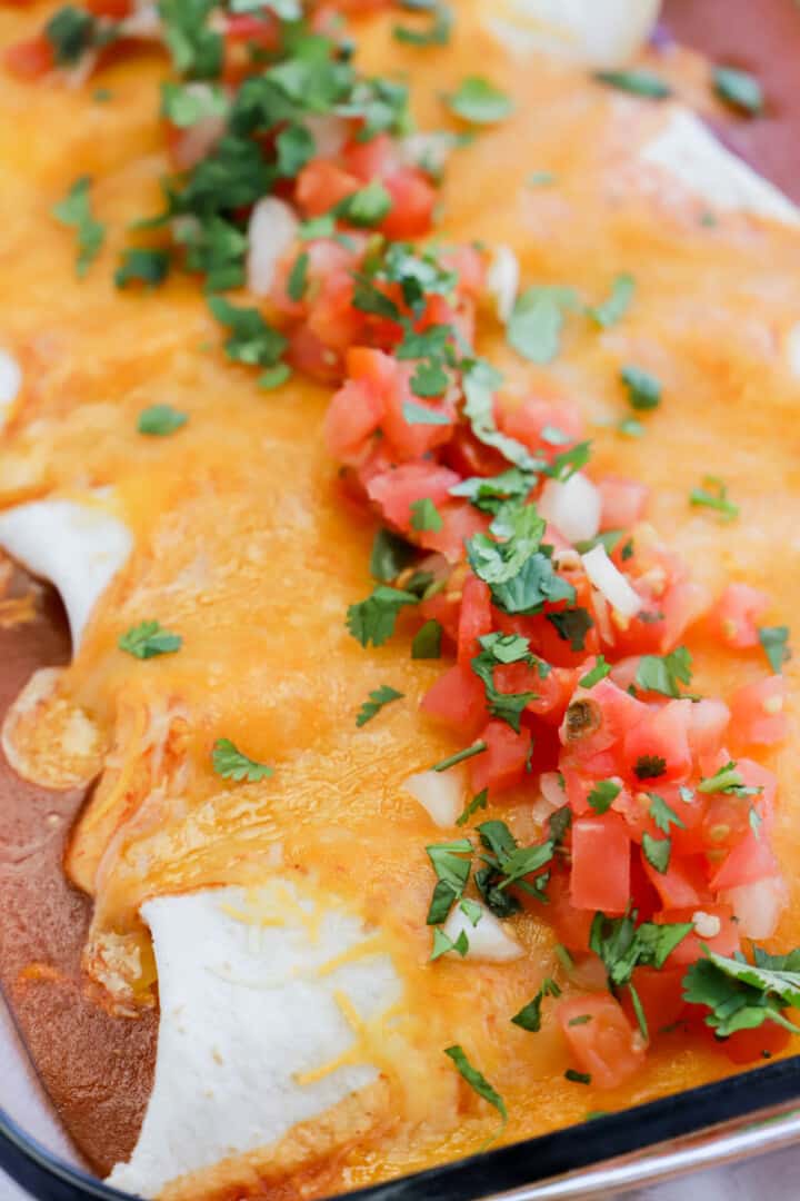 closeup of pulled pork enchiladas in casserole dish