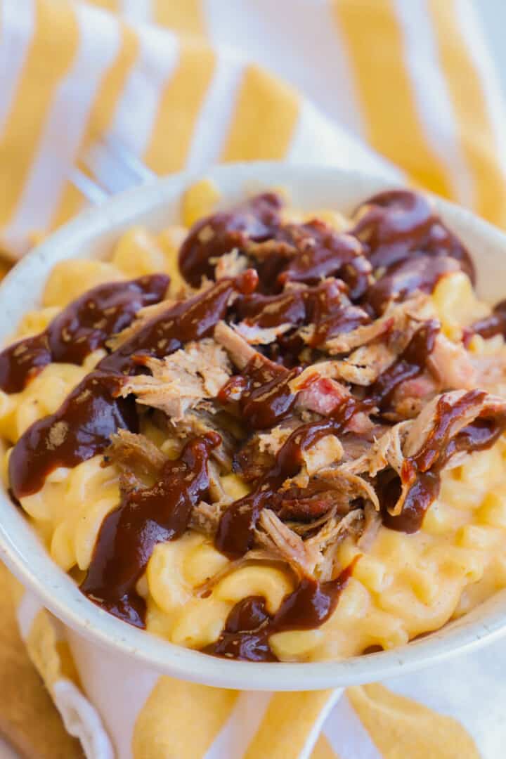 Pulled Pork Mac and Cheese in white bowl on striped towel