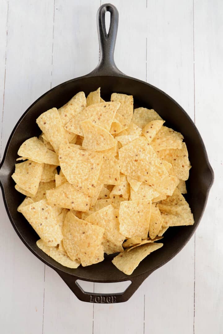 tortilla chips layered in the skillet