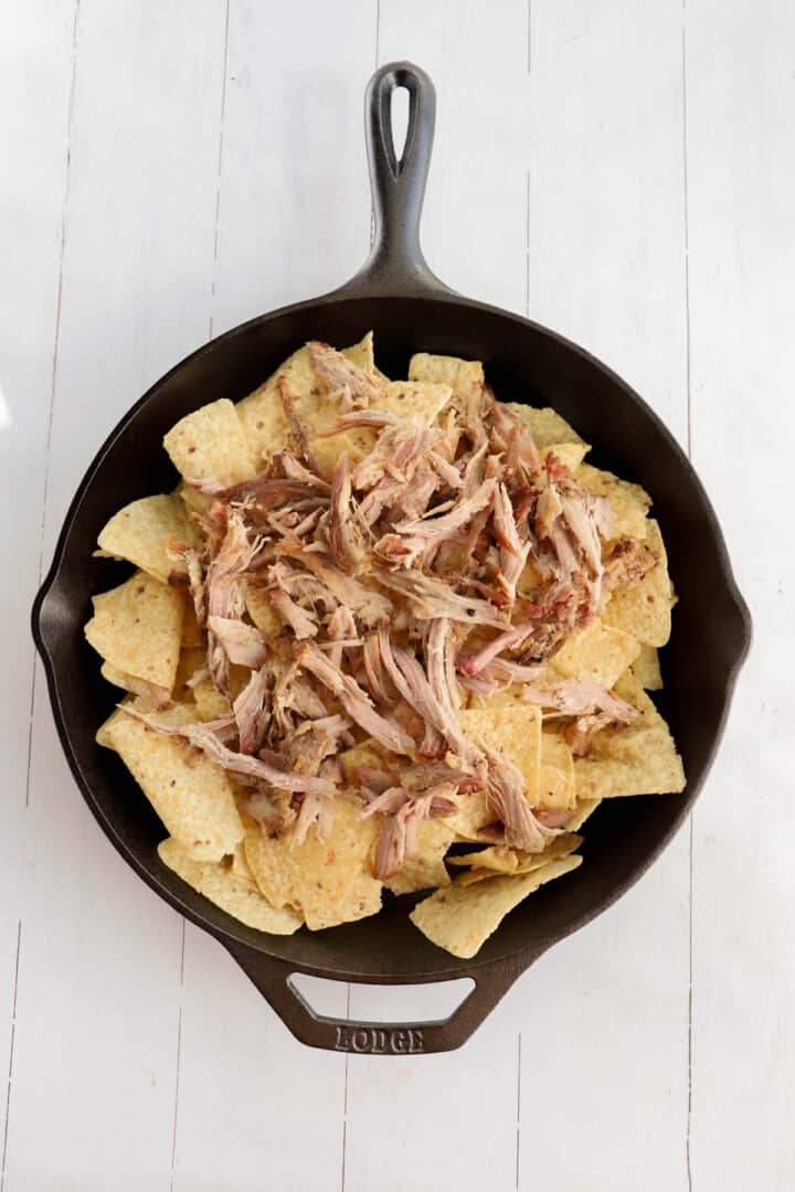 pulled pork layered on top of tortilla chips