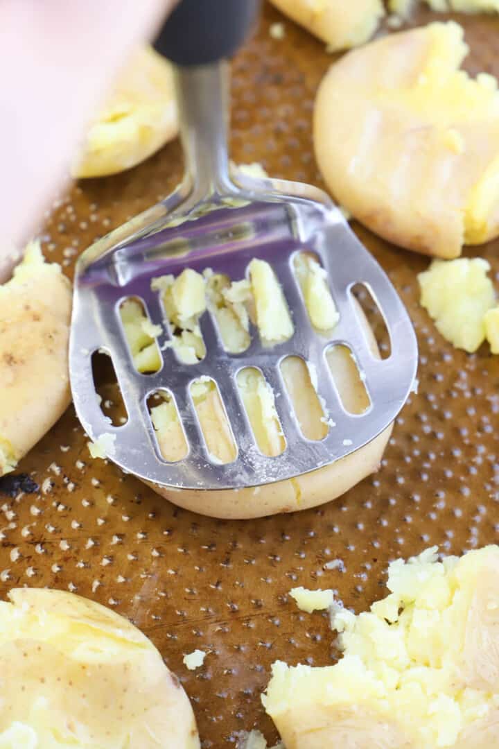 smashing the potatoes with the potato masher