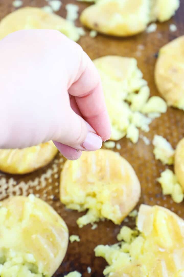 seasoning the potatoes with salt and pepper