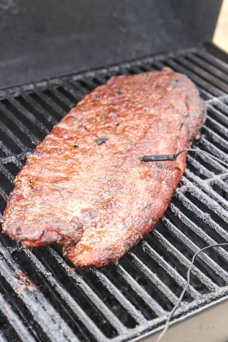 ribs on the smoker grill with thermometer in it
