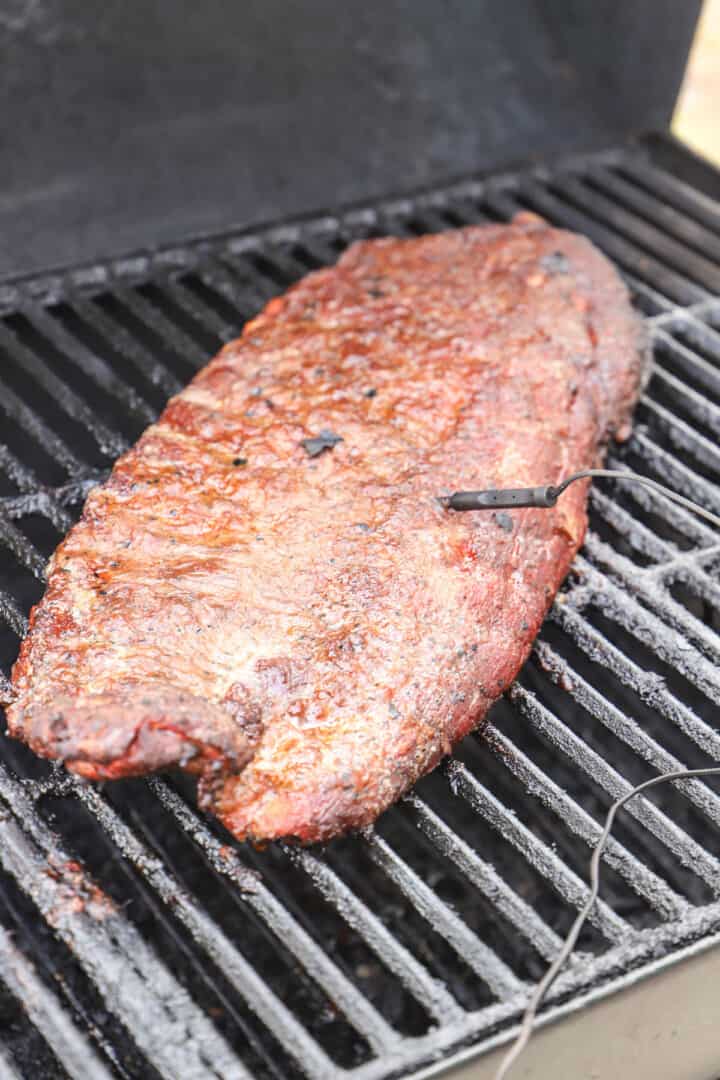 ribs on the smoker grill with thermometer in it