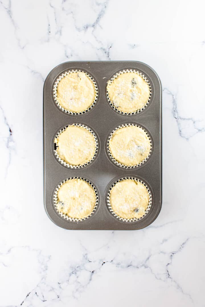 batter added to muffin tin and topped with sugar.