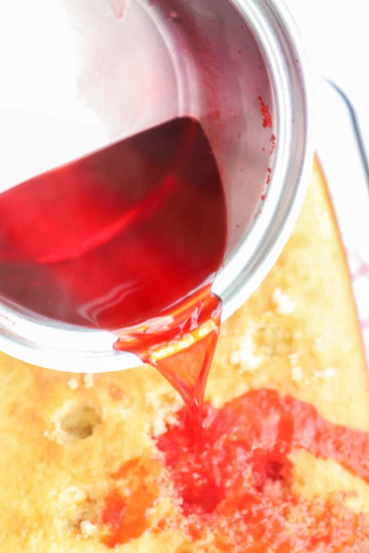 pouring Jell-o mix over poke cake