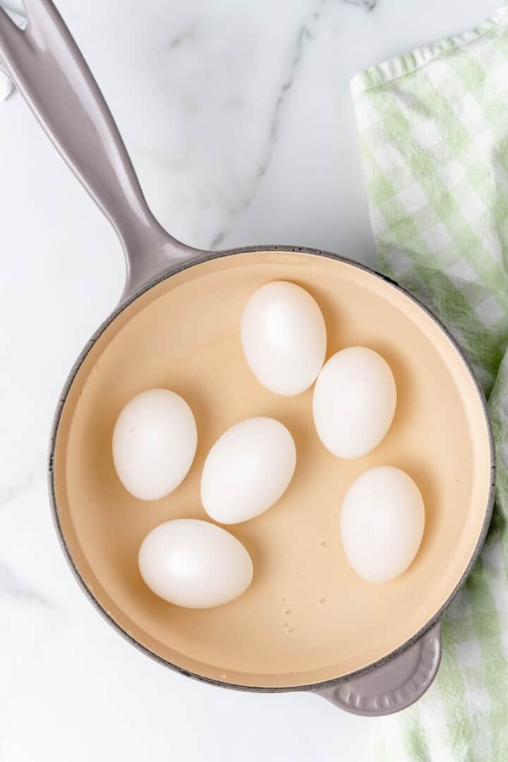 boiling eggs in a pan.