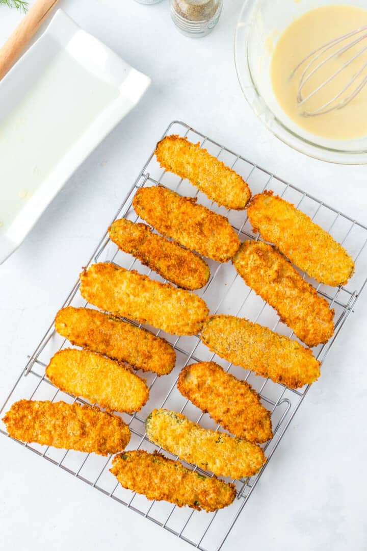 fried pickles on wire rack for cooling and serving.