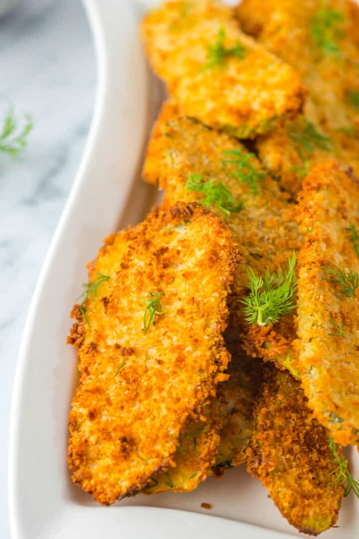 closeup of air fryer fried pickle in white serving tray.