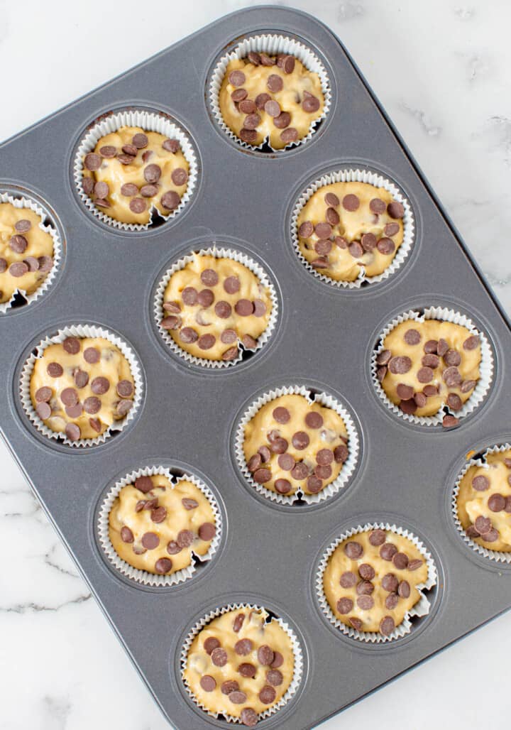 filling the muffin cups in the muffin pan