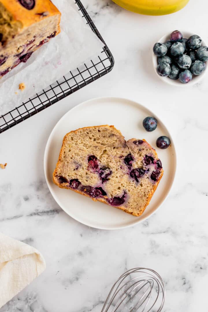 slice of blueberry banana bread on white plate