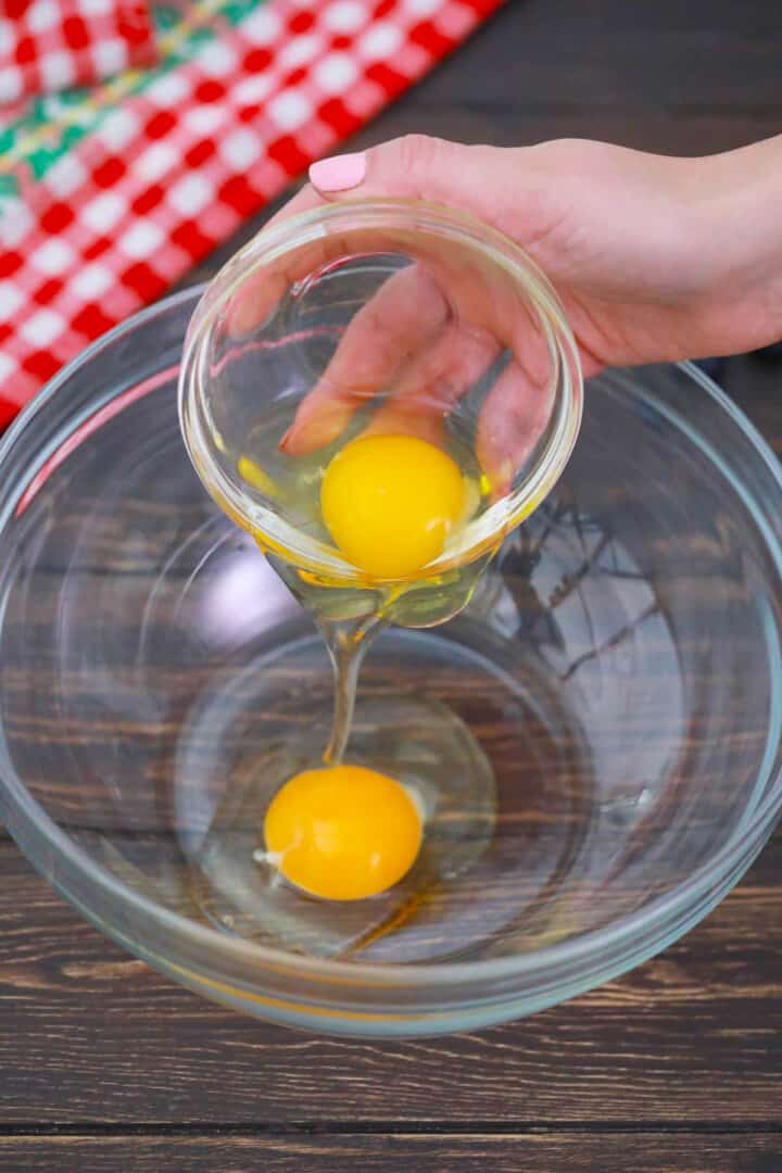 pouring eggs into large mixing bowl.