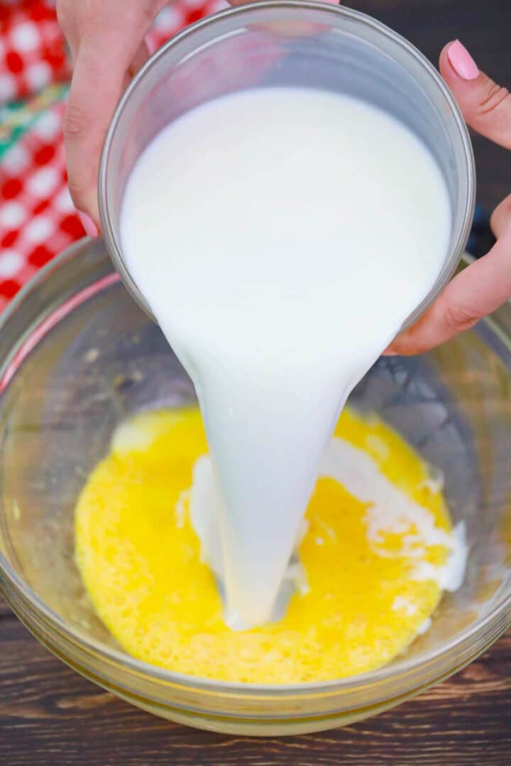 adding milk to eggs and butter.